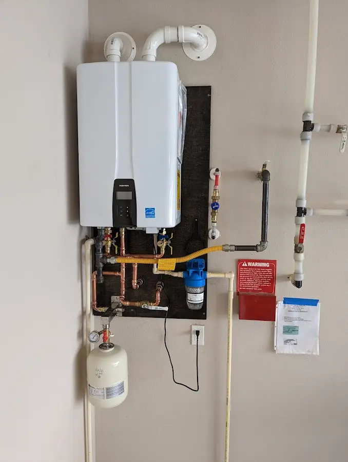 Professional plumber installing copper piping in a Tempe home